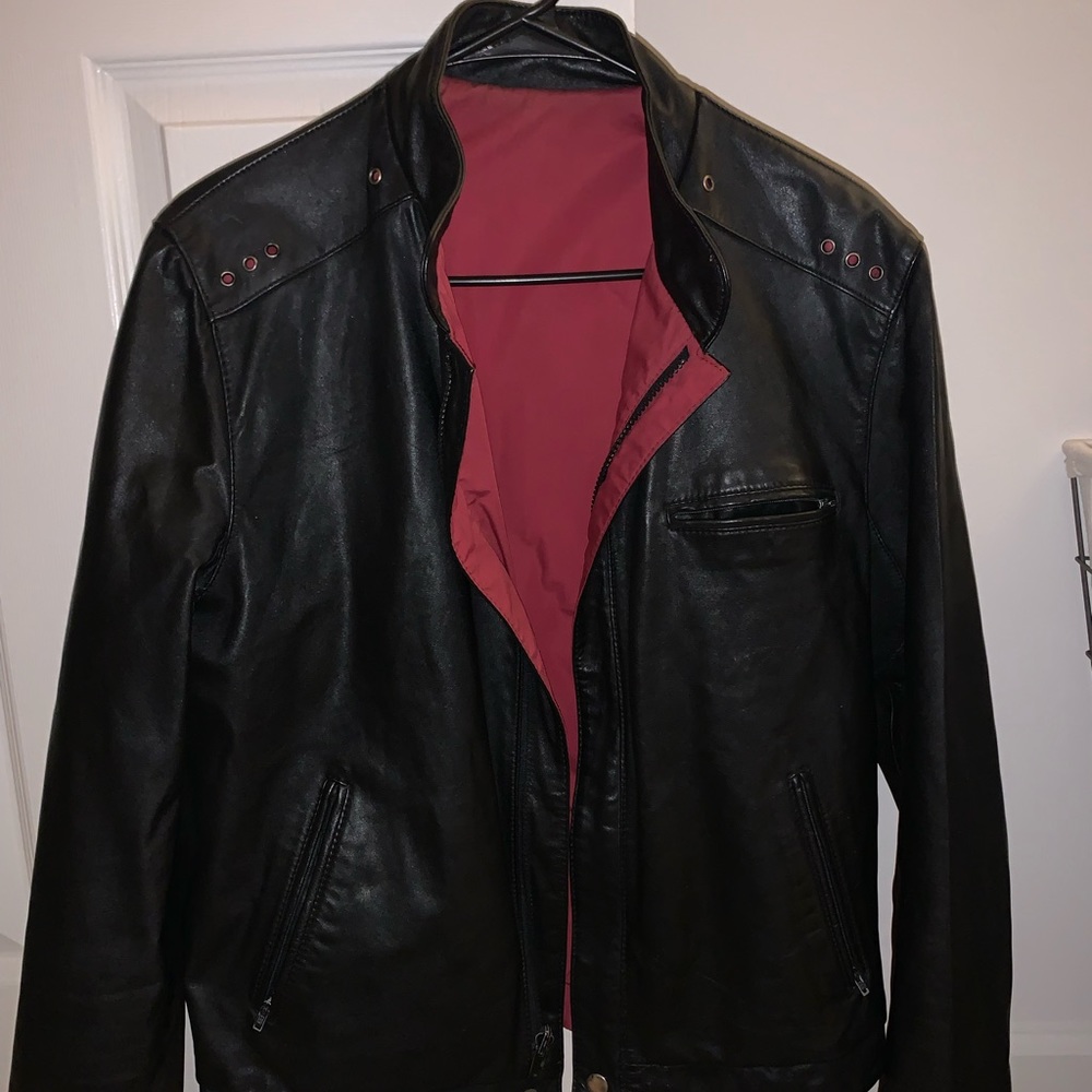 Very well kept Black Leather Jacket. Red polyester inside. metal zipper/pockets